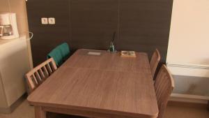 a wooden table with chairs in a room with a refrigerator at Residence VAL DAZUR VALBERG 2 PIECES in Valberg +56 photos