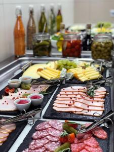 a buffet with many different types of meats and vegetables at Holiday Inn - Kyiv, an IHG Hotel in Kyiv