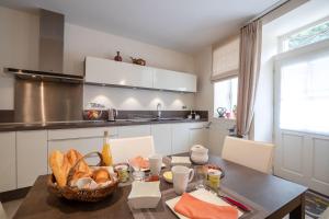 a kitchen with a table with a basket of bread at Les Demeures du Tonnelier, Maison Rue in Saint-Romain