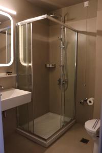 a bathroom with a shower and a sink at Hara Hotel in Chalkida