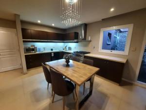 a kitchen with a wooden table and some chairs at Casa Guemes in Mar del Plata