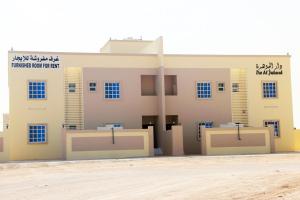 a building with two stalls in front of it at Dar Al-Jwharah in Duqm