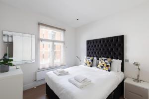 Krevet ili kreveti u jedinici u okviru objekta homely – Central London West End Apartments