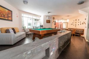 a living room with a pool table in the middle at B&B Wasi Airport Lima in Lima