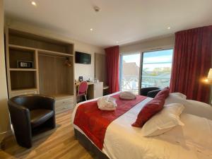 a hotel room with a bed and a window at Contact hôtel - Hôtel Les Bleuets & SPA in Honfleur +56 photos