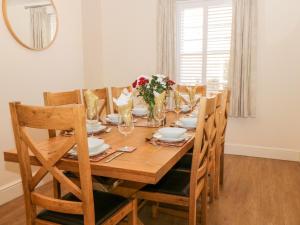 a wooden table with chairs and a dining room at Hazeldene in Whitby