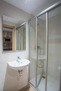 a white bathroom with a sink and a shower at micampus Bilbao Student Residence in Bilbao