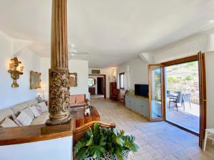 a living room with a couch and a table at Villa Don Giovanni Taormina Mare in Taormina