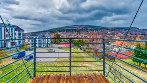 a balcony with a view of a city at Apartament Górski - 5D Apartamenty in Świeradów-Zdrój