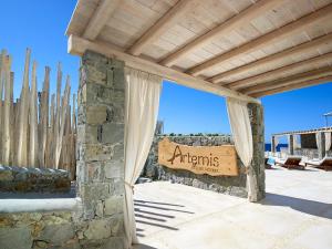 a stone building with a sign that readsagents at Artemis Seaside Resort in Paliochori