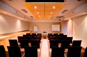 a conference room with black chairs and a podium at Miller Apartments in Adelaide