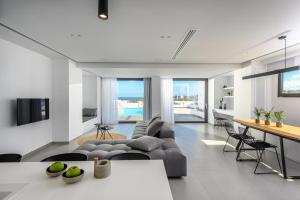 a living room with a couch and a table at Cocoon Luxury Villas in Hersonissos