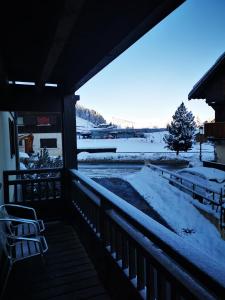 a snow covered porch with a view of a yard at Appartement Courchevel le Praz in Courchevel