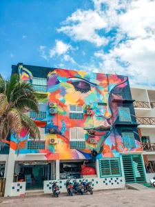 a building with a painting of a face on it at Ocean Drive Hotel in Isla Mujeres