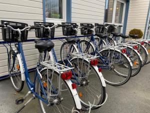 a row of bikes parked next to a building at Contact hôtel - Hôtel Les Bleuets & SPA in Honfleur