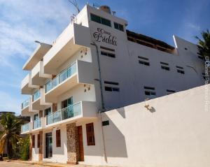 a white building with a sign on it at Hotel Casa Pridda in Puerto Escondido