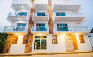 a building with balconies on the side of it at Hotel Casa Pridda in Puerto Escondido