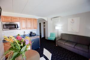 a living room with a couch and a table at Periwinkle Inn in Cape May