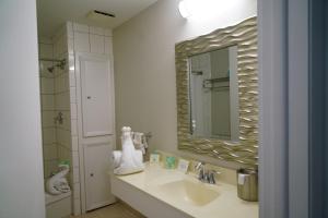 a bathroom with a sink and a mirror at Periwinkle Inn in Cape May +30 photos