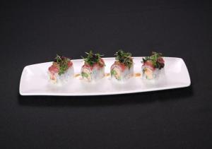 a white plate with sushi on a black table at South Point Hotel Casino-Spa in Las Vegas