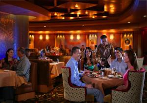 a group of people sitting around a table in a restaurant at South Point Hotel Casino-Spa in Las Vegas