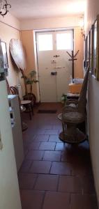 a room with a hallway with a door and chairs at Grandpa Mau in Lucca