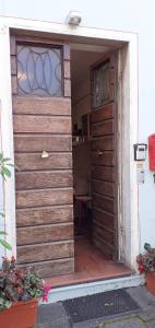 an entrance to a wooden garage with a door at Grandpa Mau in Lucca