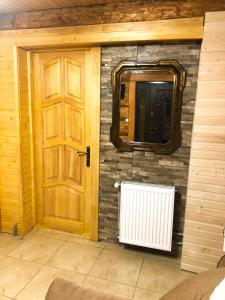 a room with a door and a radiator and a window at Зимова казка in Tatariv