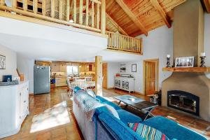 a living room with a blue couch and a fireplace at Northwoods Dream Retreat in Whitefish