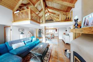 a living room with a blue couch and a wooden ceiling at Northwoods Dream Retreat in Whitefish