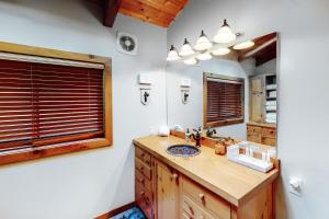 a bathroom with a sink and a mirror at Northwoods Dream Retreat in Whitefish +31 photos