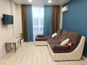 a living room with a couch and a table at Prestige Apartments in Rivne