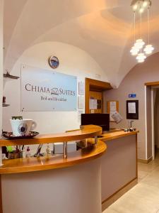 a restaurant with a counter with a sign on the wall at Chiaia Suites in Naples