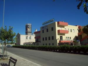 a building with a street sign on top of it at Hotel Nuova Grottella in Copertino