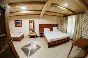 a bedroom with a bed and a mirror and a chair at Etno hotel Balasevic Rtanj in Boljevac +105 photos