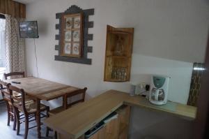 a kitchen with a table and a table and a counter top at le bel aval in Les Contamines-Montjoie