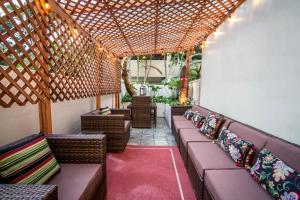 a pergola with chairs and tables in a patio at The Equus in Honolulu