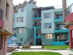 a blue apartment building with stairs and a yard at Dream Bay Apartments in Tsarevo