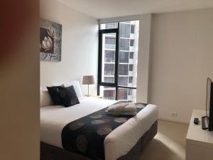 a hotel room with a bed and a window at Accent Accommodation@Docklands in Melbourne
