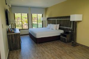 a hotel room with a bed and a window at Rado Hotel - Quintanas in Trujillo