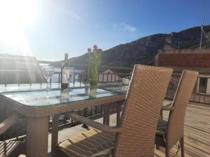 a table and chairs on a deck with a view at Apartments Villa Beba in Komiža