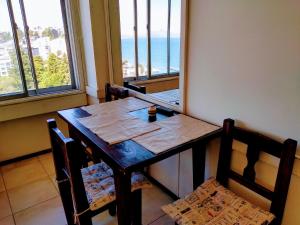 a table and chairs in a room with a view of the ocean at Apartamento Bariloche Center in San Carlos de Bariloche