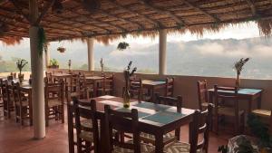 a restaurant with tables and chairs with a view at Hotel CaféNaranja Xilitla in Xilitla