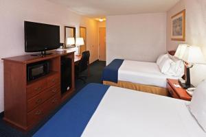 a hotel room with two beds and a flat screen tv at Ramada by Wyndham Santa Fe in Santa Fe +29 photos