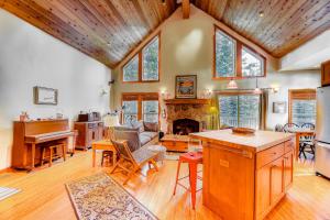 a kitchen and living room with wooden ceilings and a fireplace at Sugar House in Soda Springs