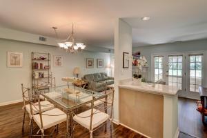 a kitchen and living room with a glass table at 110 Evian 2 BR Shipyard in Hilton Head Island