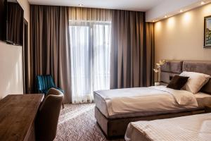 Ένα ή περισσότερα κρεβάτια σε δωμάτιο στο NEW Garni Hotel FILIA