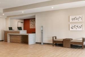 an empty lobby with a reception desk and chairs at Candlewood Suites Fayetteville Fort Bragg, an IHG Hotel in Fayetteville