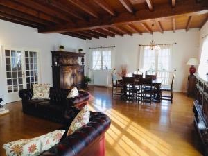 a living room with a couch and a dining room at Charming Country Estate in Dournazac