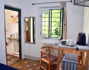 a kitchen with a table and a chair in a room at Garden Atelier Eco Friendly in La Cumbre